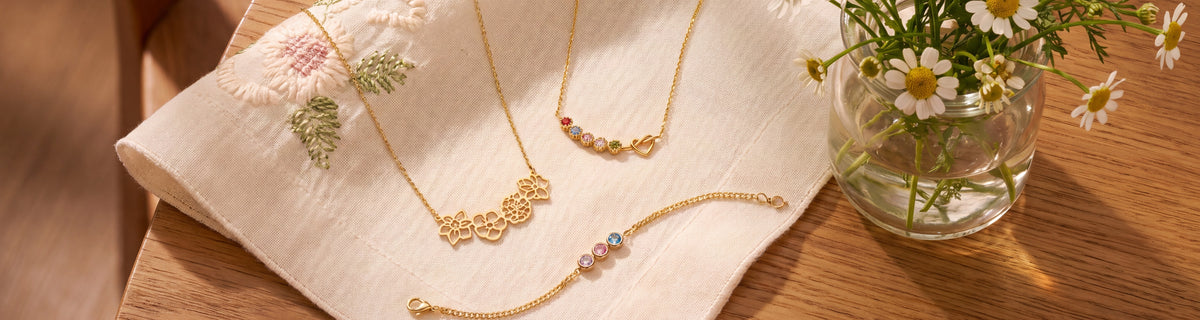 Birth flower and birthstone jewelry for grandma on embroidered linen with chamomile