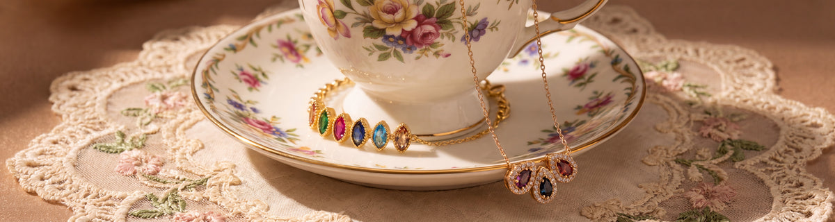 Birthstone necklaces and bracelet for mom on a floral teacup and lace